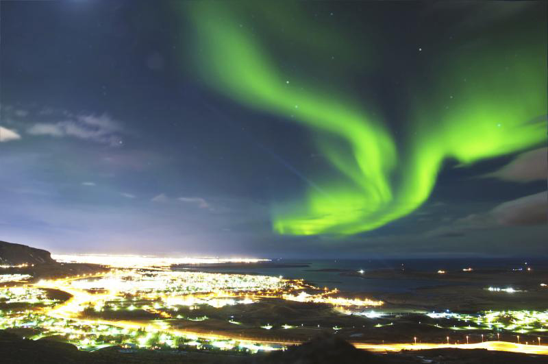 Spectacular display of green Northern Lights over Reykjavik